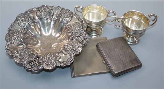 A late Victorian pierced silver dish, Birmingham, 1899, two small silver trophy cups and two silver cigarette cases.